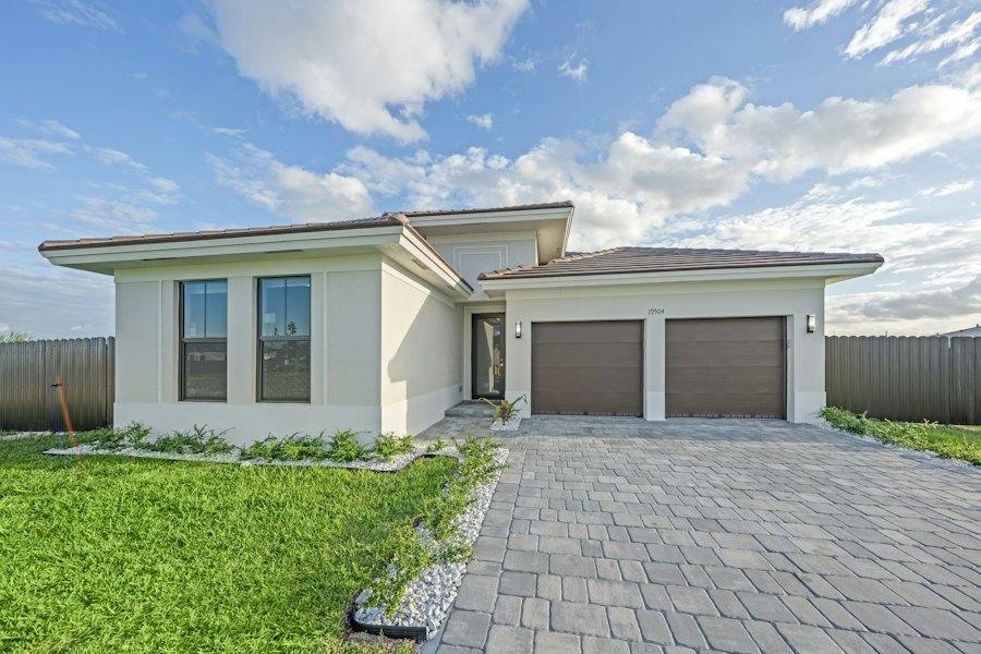 A modern single-storey family home with a double garage and paved driveway